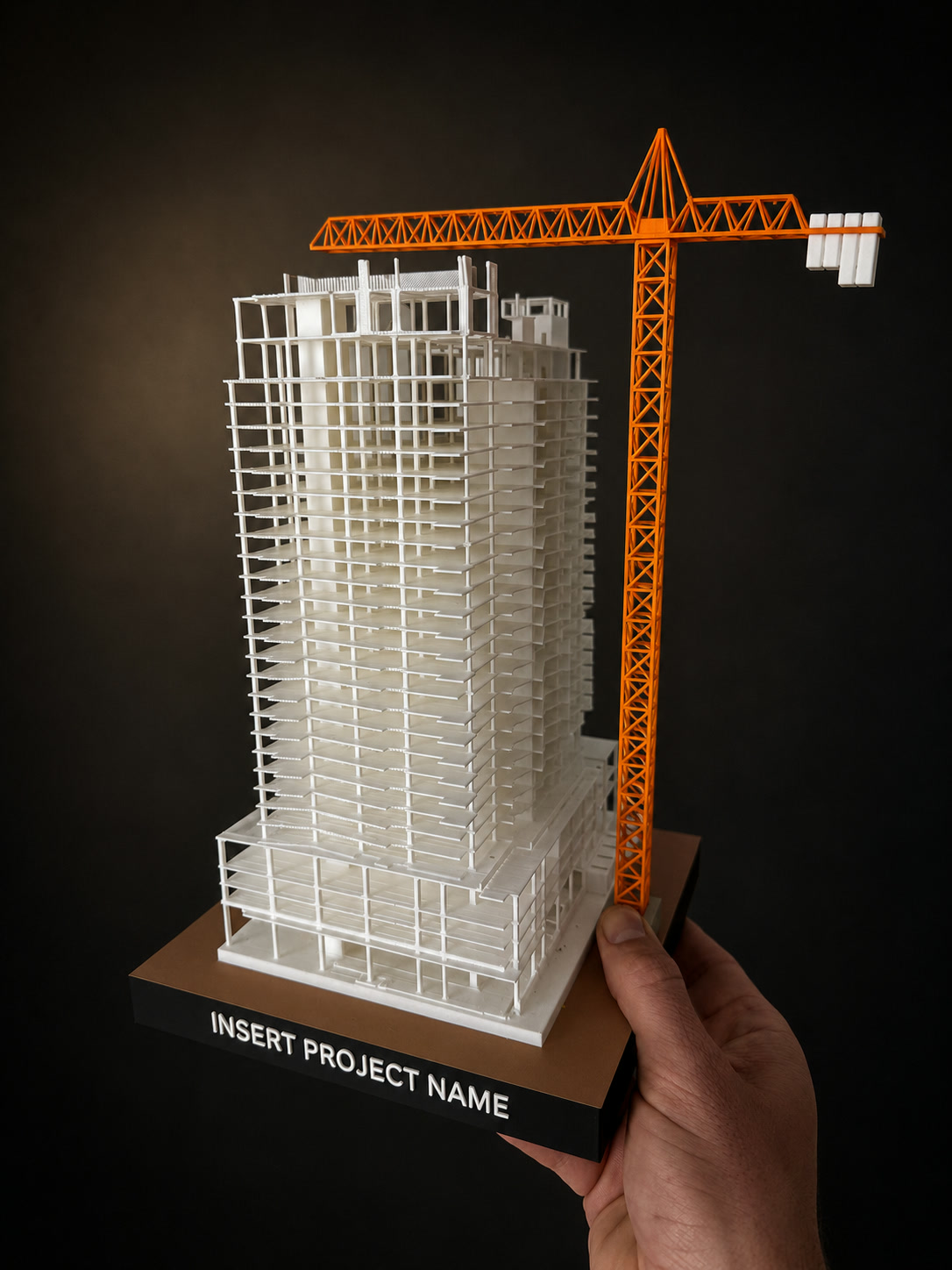 3D-printed structural scale model of a high-rise tower with an orange tower crane, printed from the project's construction model