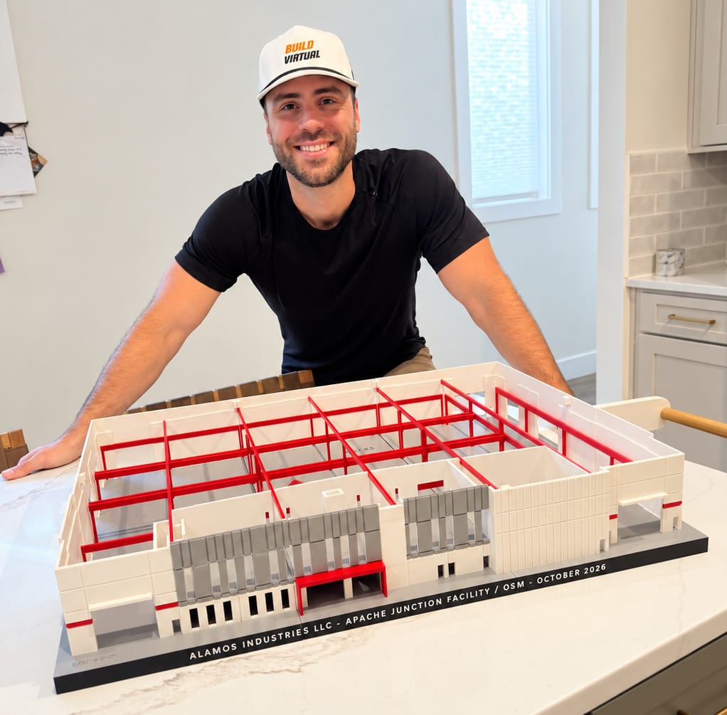 Colby, owner of Build Virtual, behind a 3D-printed model of a 65,000 sq ft industrial facility